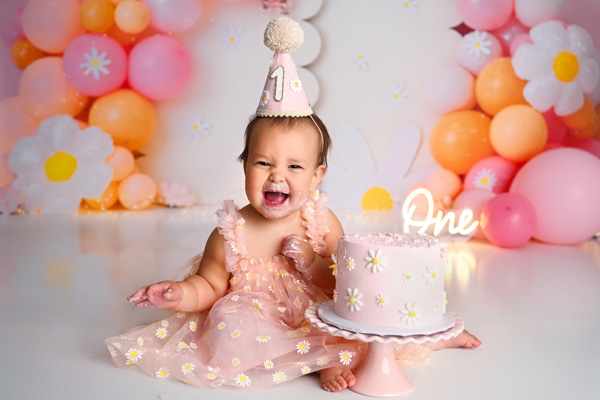 One year old baby celebrating a cake smash session
