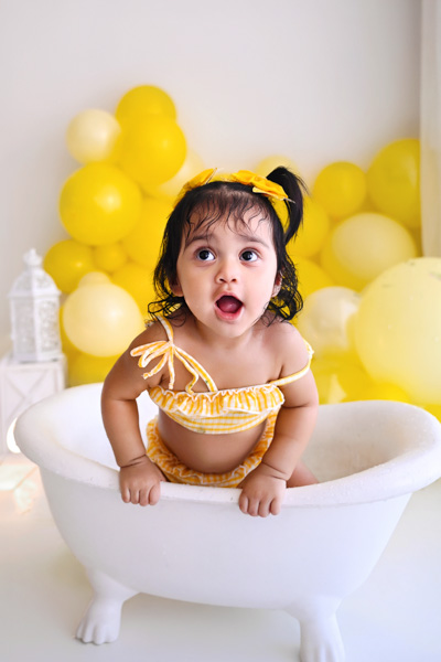 One year old baby with a celebration cake