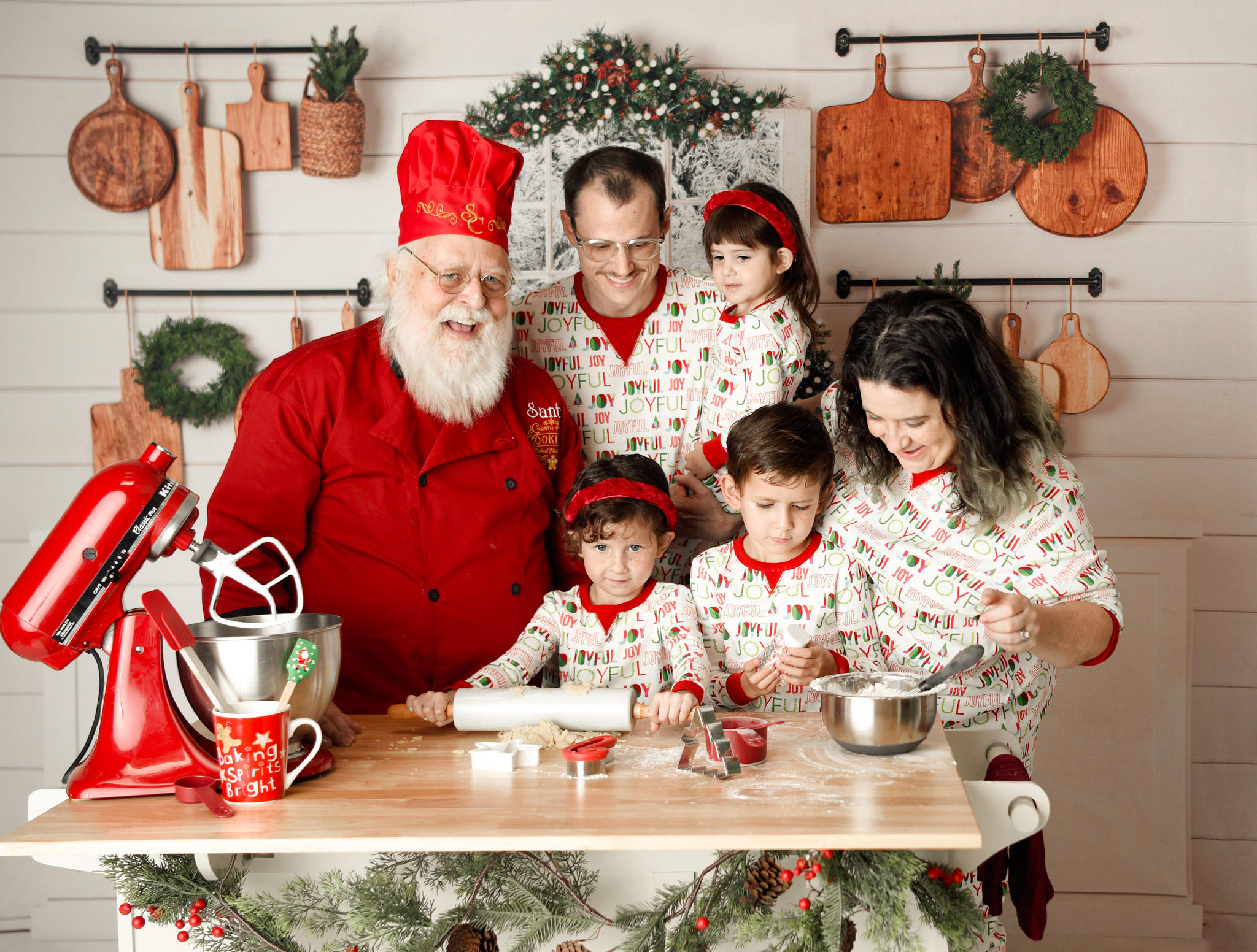 Family and Santa Claus cooking and smiling