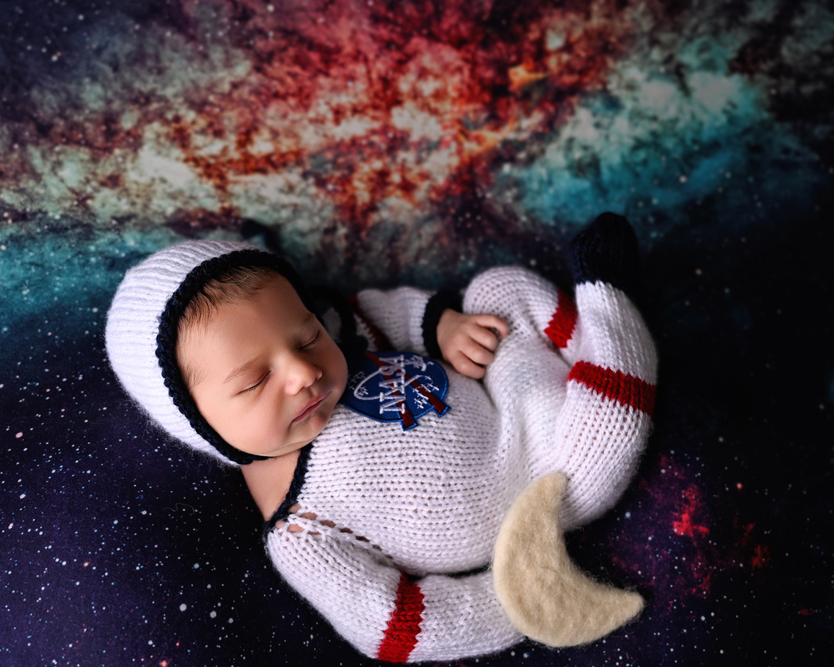 Olivia Grace holding a newborn baby during a photography session in Sun City, AZ