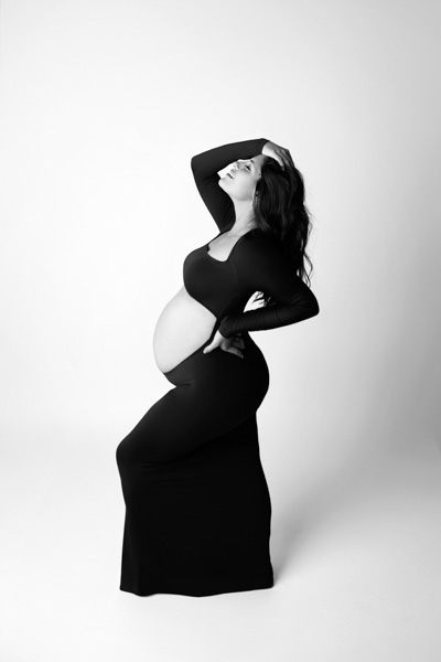 Pregnant woman embracing her belly