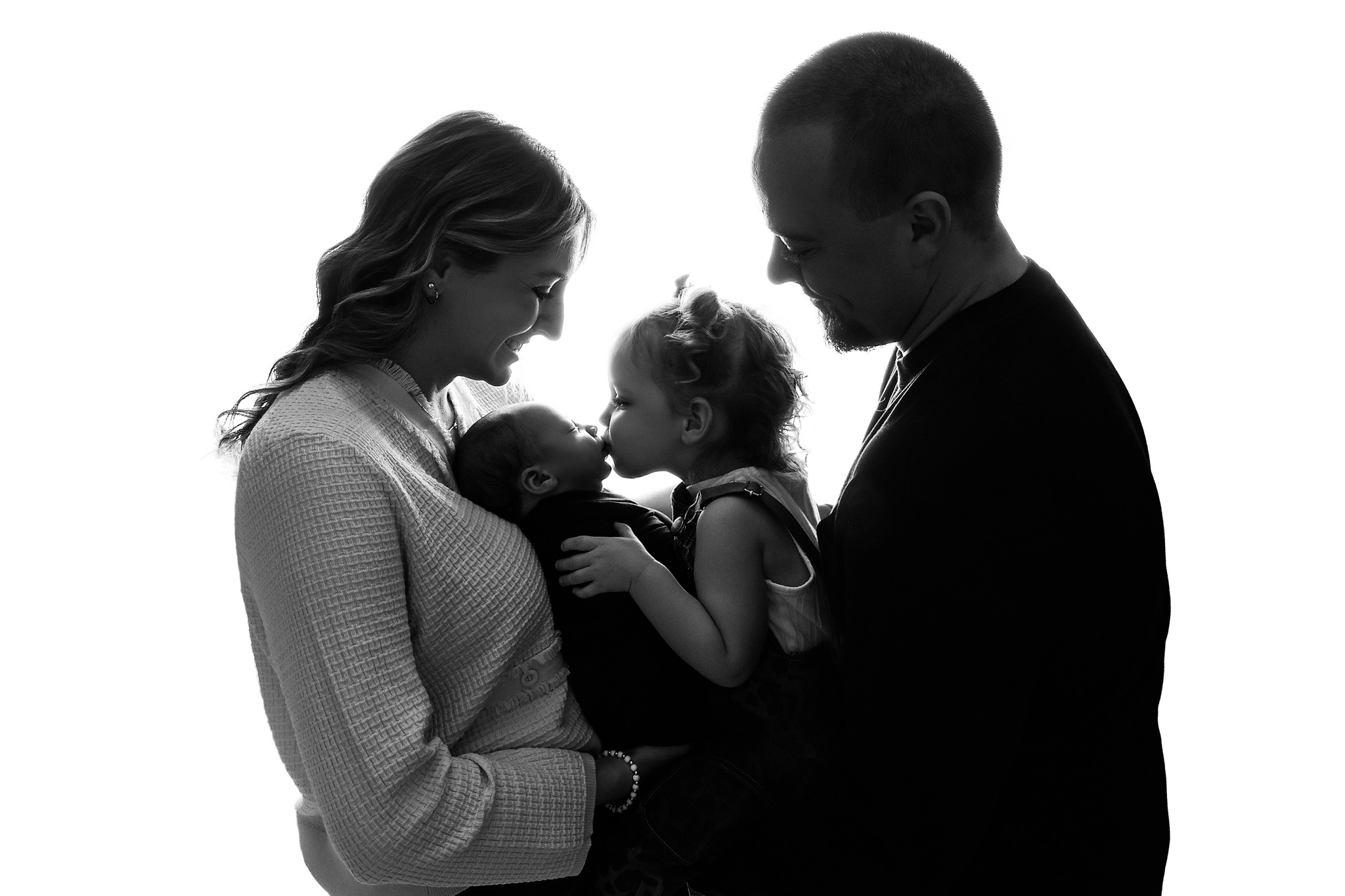 Olivia Grace holding a newborn baby during a photography session in Sun City, AZ