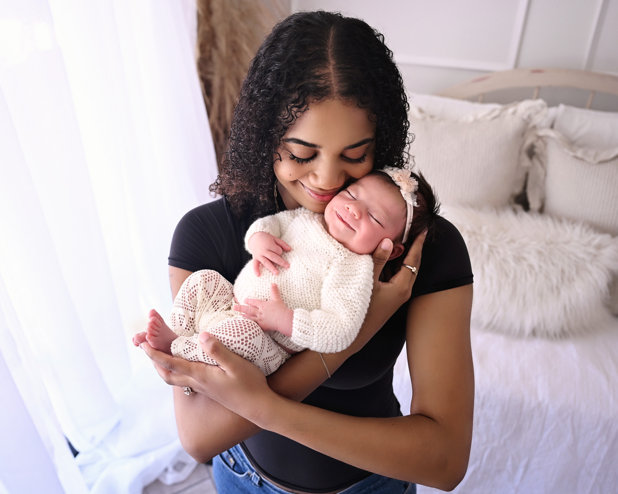 Mother holding a newborn baby during a photography session in Ahwatukee, AZ