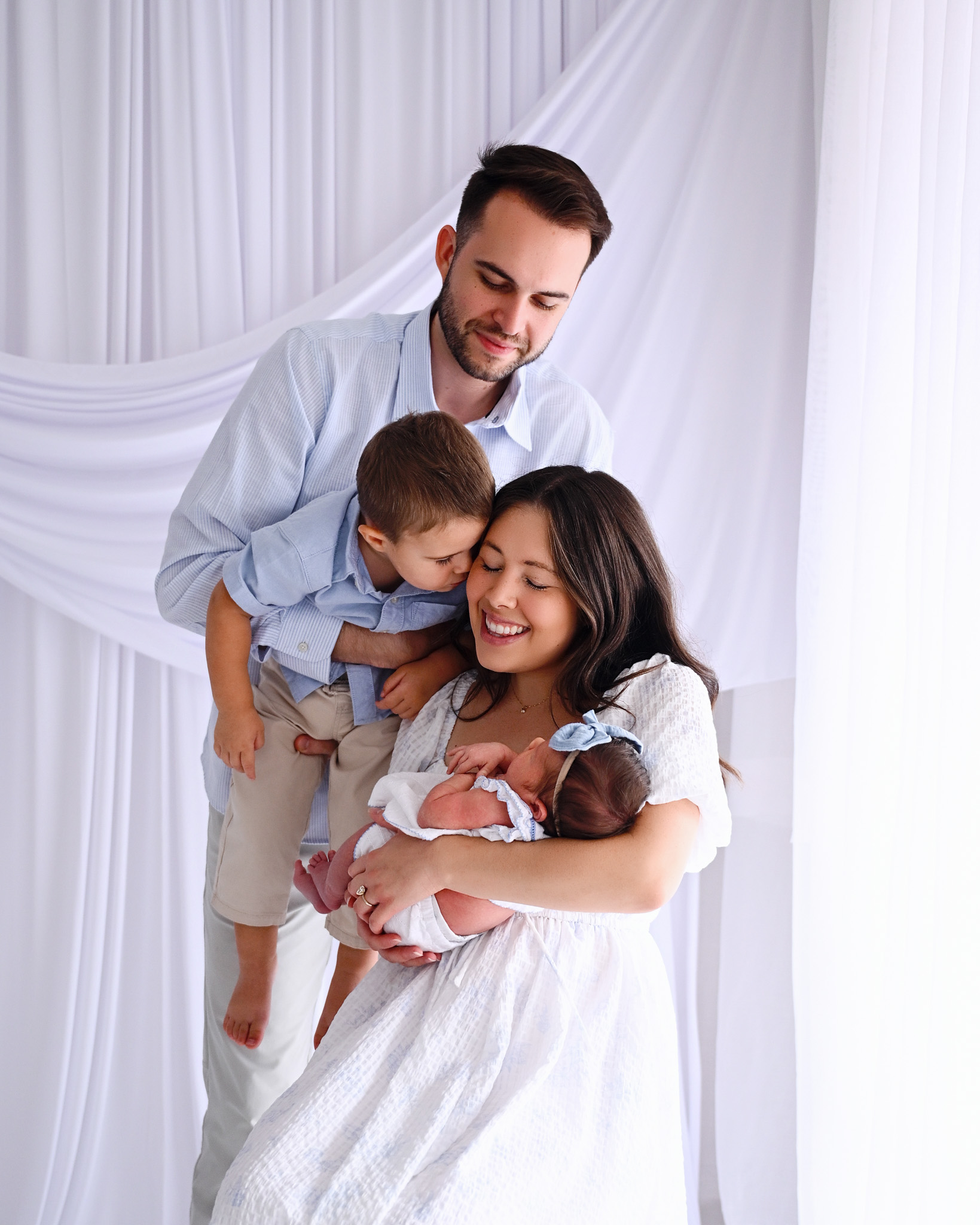 Family together with a newborn baby